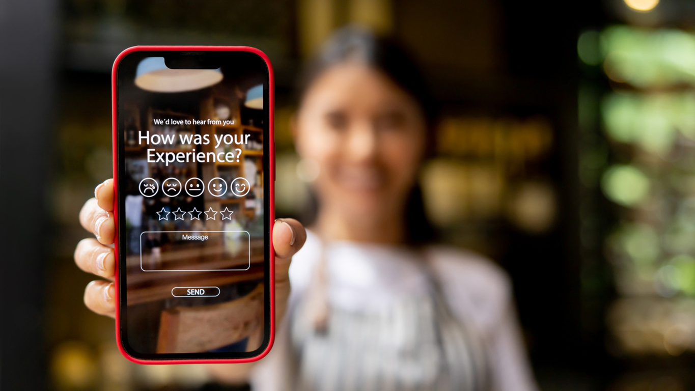 Person holding a smartphone displaying a customer satisfaction survey with a star rating